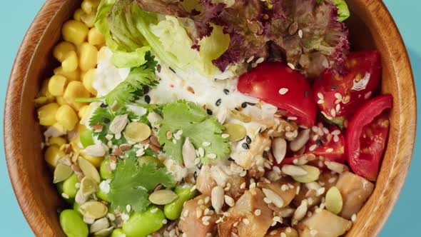 Poke Bowl Salad on Blue Background