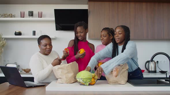 Joyful African Family Filling Tray with Fresh Fruits and Vegetables