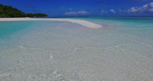 Wide overhead travel shot of a summer white paradise sand beach and blue water background in vibrant