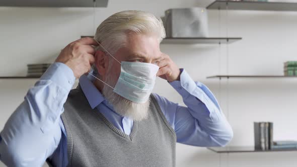 Close Up Portrait of Elderly Man in Medical Face Mask.