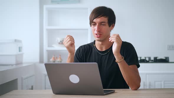 Cheerful Young Business Man Call Video Chat on Laptop Computer at Remote Workplace Sitting at