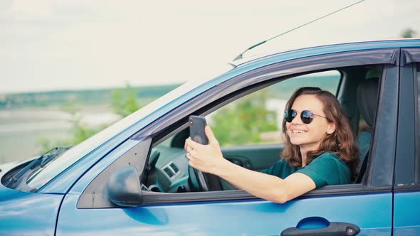 A Young Woman Taking a Video Call or Recording Video for Her Vlog with a Phone