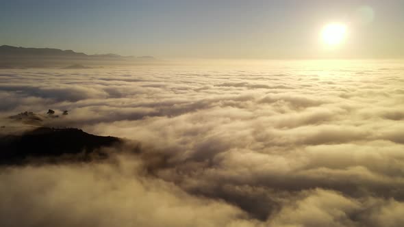 Aerial time lapse of low clouds at dawn