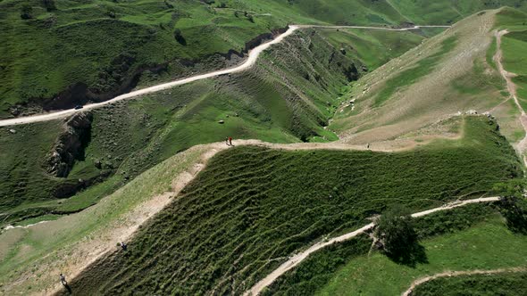 Long rural roads covering green hills