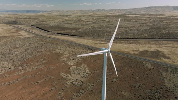 Eastern Washington Windmill Spinning With People Driving On Scenic Road Trip