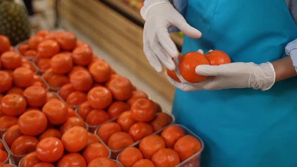 Gloved Hands of Female Grocery Store Staff at Work