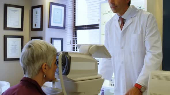 Optometrist examining patient eyes with autorefractors 4k