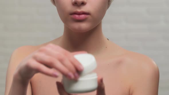 Incognito Woman in Towel Showing Cream