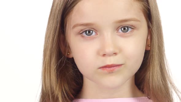 Little Girl Genuinely Smile at the Camera. White Background. Close Up