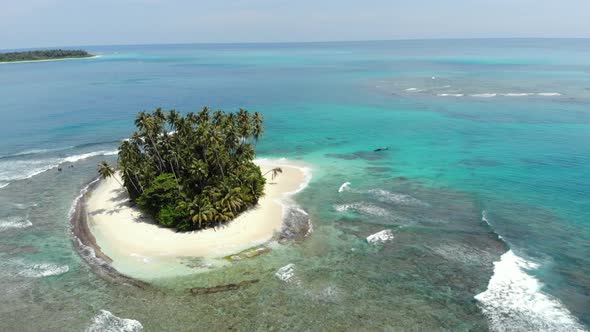 Aerial: flying over tropical island white beach caribbean sea turquoise water