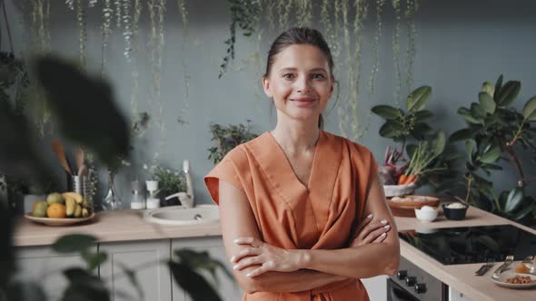 Happy Woman Posing in Cozy Kitchen