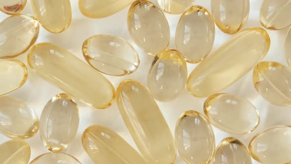 Yellow Oil Capsules Vitamin C Omega 3 Rotating Closeup