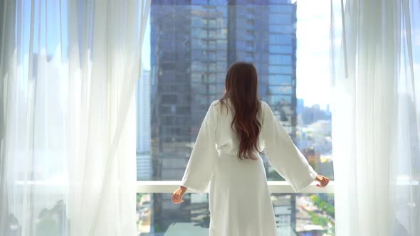 Asian woman relax on bed in bedroom interior