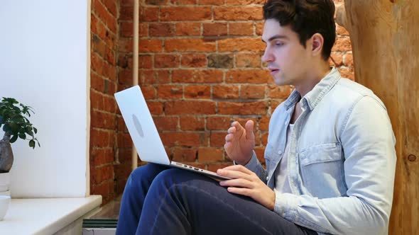 Shocked Young Man, Amazed by Surprise on Laptop