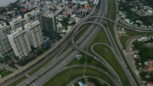 Top  down aerial view of freeway interchange with interesting looped roads and traffic. Camera pans