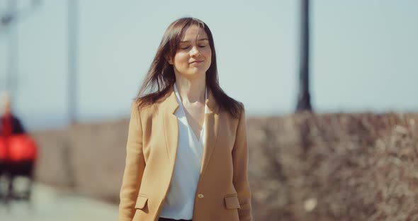 Beautiful Young Woman Walks Along the Paths of the Park and Enjoys Life