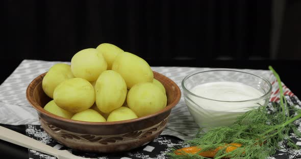 Boiled New Delicious Potato on Plate on Table Ready To Eat. Dill, Sour Cream