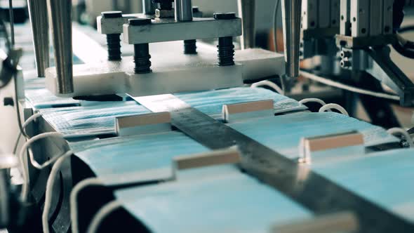 Earloop Attaching Machine at a Medical Mask Manufacturing Facility. Coronavirus Protection Mask