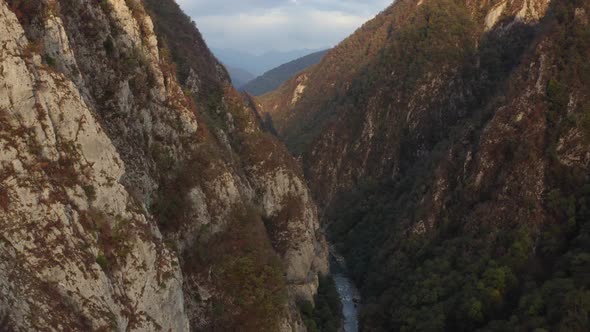 Flying Over Natural Akhtsu Gorge Surrounded By Cliff Formation Covered By Plants