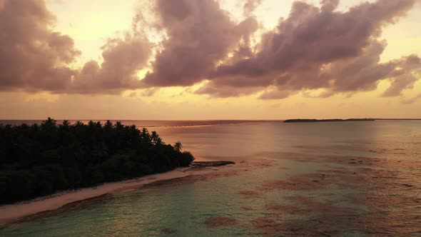 Aerial drone shot seascape of perfect tourist beach trip by aqua blue sea with white sandy backgroun