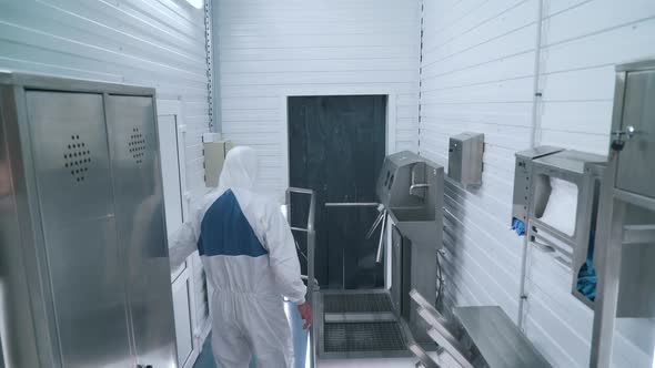 a Factory Worker Disinfects Hands