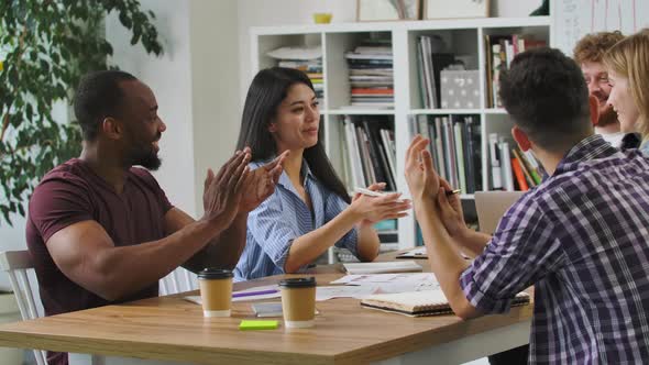 Happy Creative Startups Clap During Corporate Brainstorming Session in Modern Office