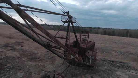 FPV Drone Flies Smoothly Near Rusty Abandoned Walking Excavator