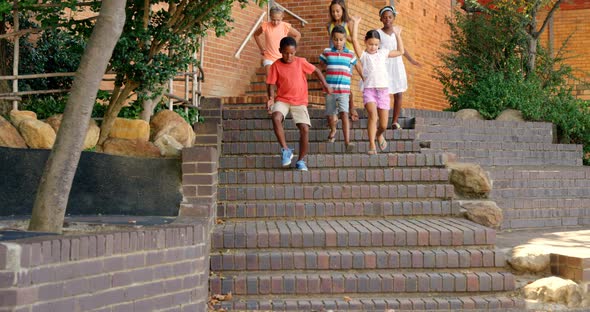 Group of kids getting down from staircase