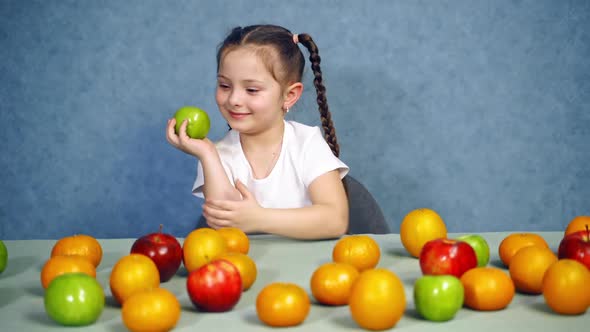 Little girl with fruits. Portrait of cute cheerful little girl with fruits