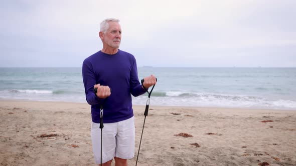 Mature Man Exercising At The  Beach