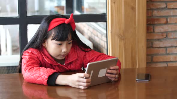 Child Holding The Tablet Computer