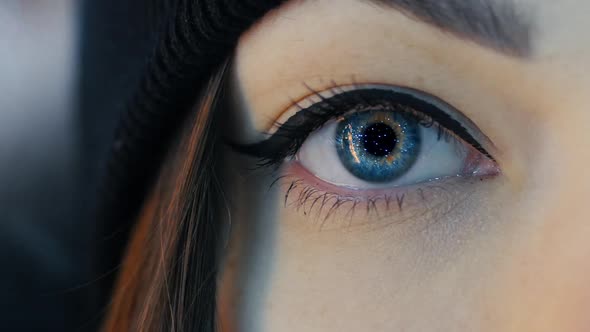 Closeup of Female Eye Opening with Beautiful Blue Iris