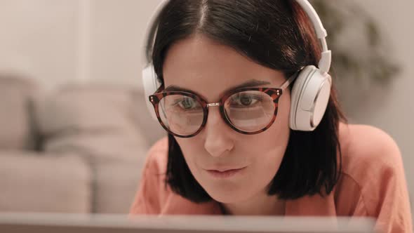 Young Woman Wearing Glasses and Headphones