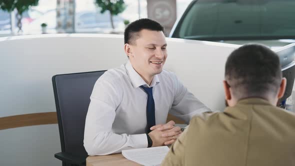 A Married Couple Buys a New Car in a Car Dealership