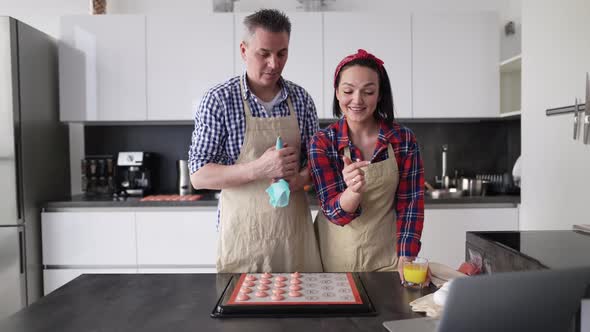 Couple at Kitchen Making Macaroons at Home Talking on Camera