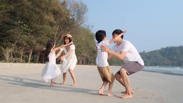 Asian Family playing together at beach with kids happy vacation travel beach concept