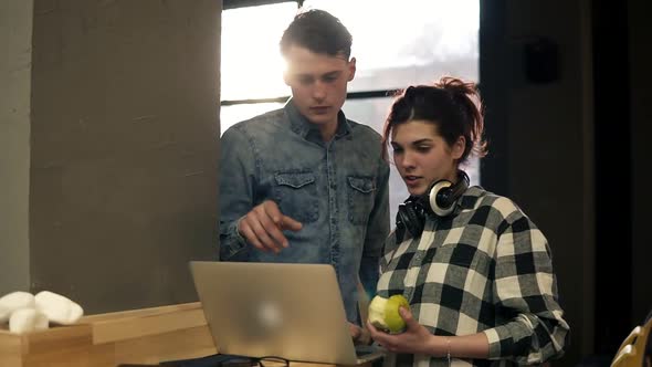 Couple of Two Stylish People a Guy and a Girl in Urban Modern Outfits Surfing the Web in Well Lit