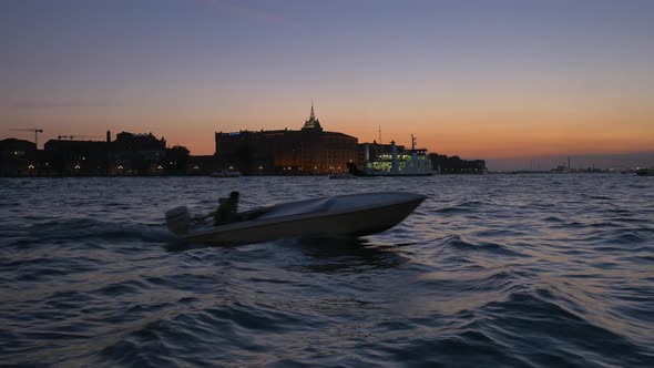 Boats sailing on Grand Canal at dusk