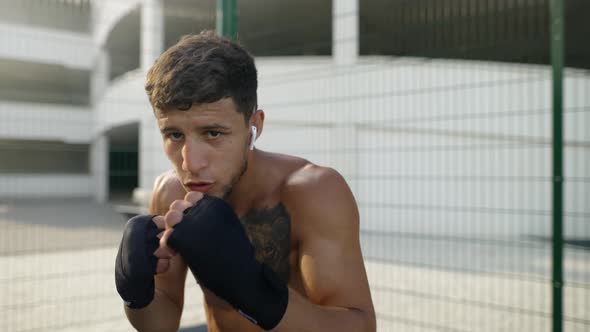 Boxer Practicing Punches in Front Camera Outdoors