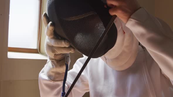 Fencer athlete during a fencing training in a gym