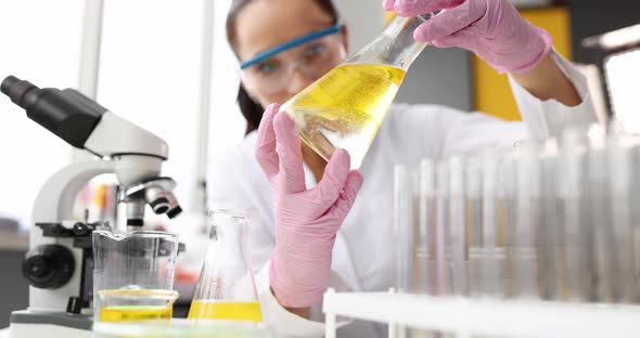 Chemist Holding Test Flask with Chemical Liquid and Fuel for Cleaning