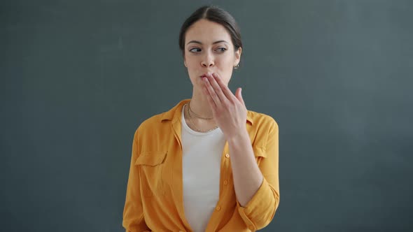 Portrait of Goodlooking Young Lady Looking at Camera Winking and Sending Air Kiss