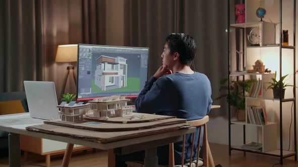 Male Engineer Thinking Then Raising Index Finger While Designing House On A Desktop At Home