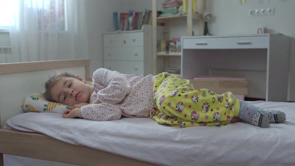 Sick Little Girl Lying in Bed