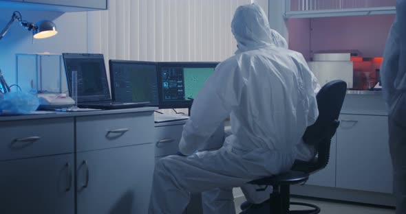 Scientists Watching Monitor in Laboratory