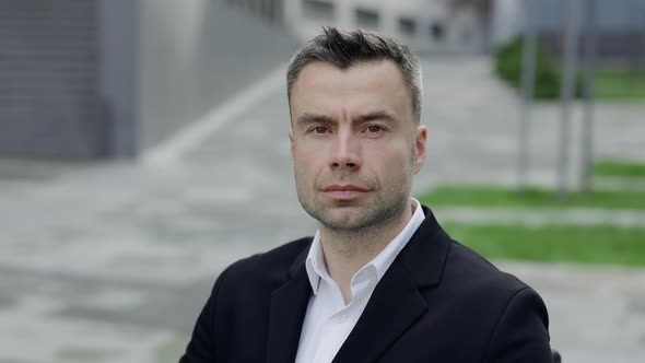 Close Up View of Serious Mature Businessman Looking To Camera