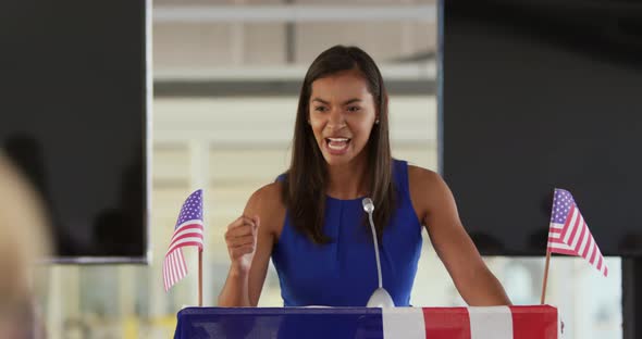 Female speaker addressing the audience at a political rally