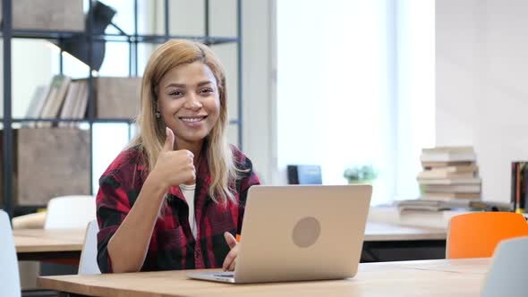 Black Woman Working on Laptop, Thumbs Up toward Camera