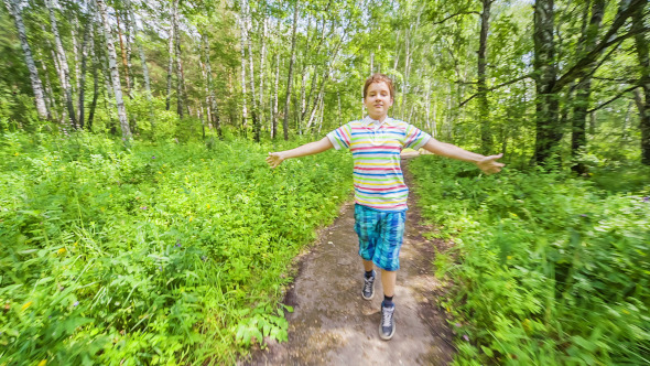 Teenage Boy Jogging in Wood  alt