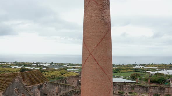 Breathtaking Drone Shot of Brick Pole and Sea Horizon